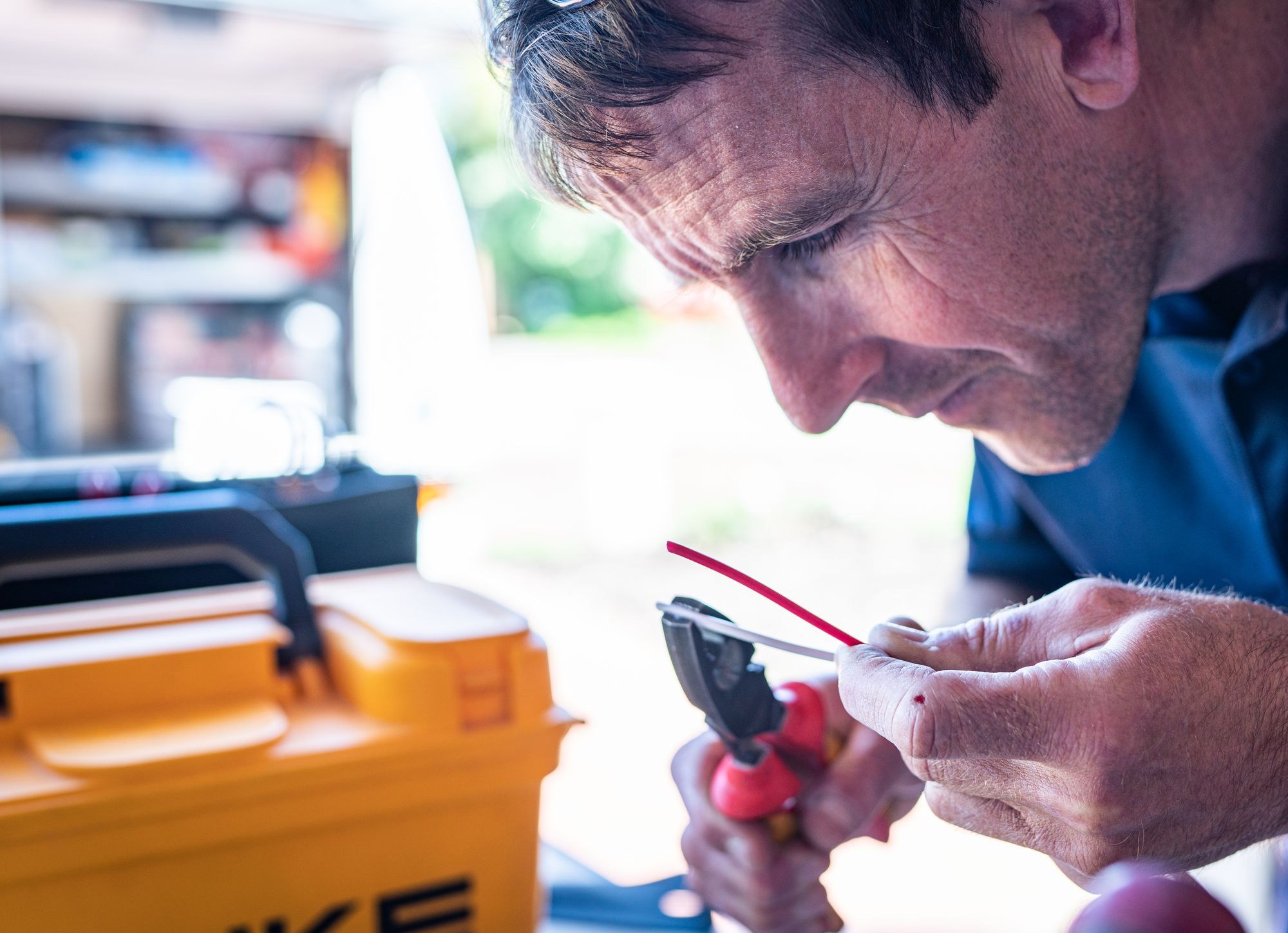 Owner personally wiring a connection on-site, hands-on with every job